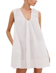 Detail of a white sleeveless V-neck dress with pleated accents and wide straps