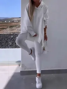 Women's white two-piece lounge set with hooded slit sweatshirt and skinny leggings