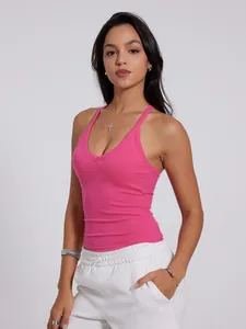 Close-up detail of women's pink ribbed V-neck sports tank top with cross-back straps
