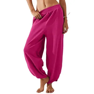 Detail shot of magenta loose-fitting lantern pants with elastic waist and pockets
