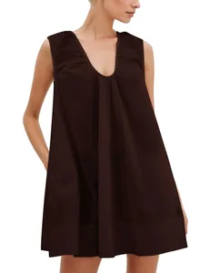 Close-up view of the deep V-neck and pleated detailing on a brown sleeveless mini dress