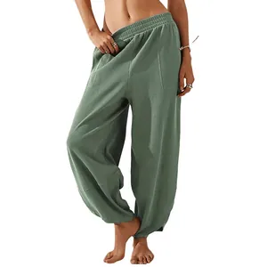 Full front view of sage green loose-fitting casual harem pants with elastic waist and pockets