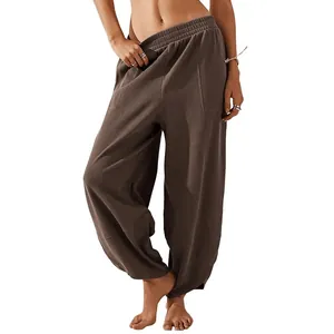Casual loose women's harem pants with elastic waist and pockets in brown color