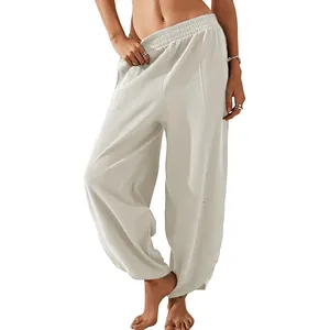 Women's white loose casual harem pants featuring an elastic waist and side pockets