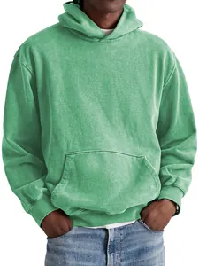Macro detail view of a green acid-washed vintage cotton hoodie featuring a kangaroo pocket