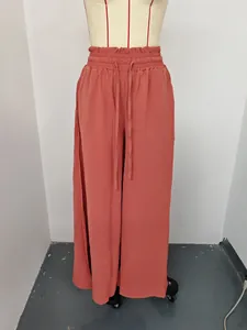 Detailed view showing the elasticated high waist and drawstring of these coral wide-leg pants