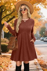Close-up of the ribbed texture and side pocket detail on a terracotta long-sleeved dress.
