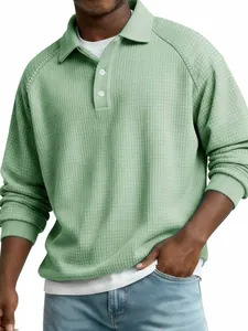Close-up of men's sage green waffle knit long sleeve polo shirt showing raglan sleeve detail