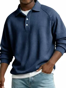 Macro view of blue waffle knit fabric on men's long sleeve raglan sleeve polo shirt