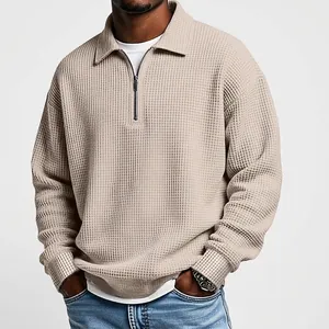 Close-up detail of a men's retro waffle knit half-zip polo shirt in a stylish khaki beige color