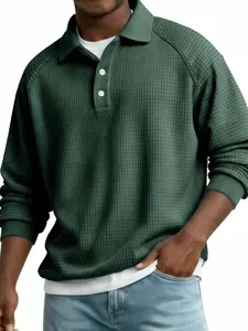 Detailed macro view of dark green waffle-knit men's polo shirt with buttoned lapels