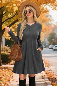 Model wearing dark grey long sleeve ribbed mini dress with pockets in autumn setting