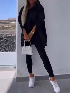 Women's black two-piece sports set with oversized hoodie and leggings for cool autumn