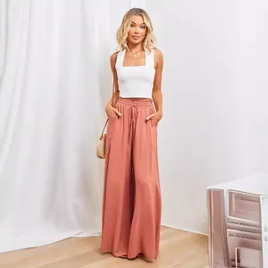 Elegant women's high waisted wide leg trousers and sleeveless crop top set for summer wear.