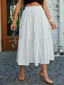 Detailed view of a white polka dot tiered maxi skirt styled for summer outdoor wear.