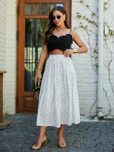 Summer 2025 white polka dot tiered maxi skirt styled with black crop top and accessories