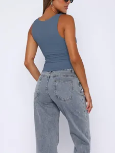 Back view of a grey-blue double-layered tank top paired with light blue denim jeans