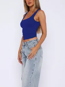 Side profile of a vibrant blue double-layer athletic tank top for women paired with jeans