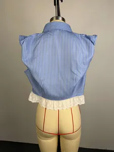Back view of blue striped shirt featuring white eyelet lace trim and structured shoulders