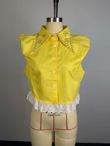 Close-up of yellow striped shirt collar with sparkling rhinestones and lace detail