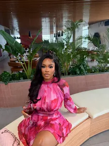 Elegant pink floral pleated A-line mini dress for summer occasions in restaurant setting