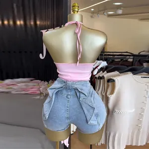 Rückansicht eines rosa Neckholder-Crop-Tops mit stylischen Jeansshorts an einer Schaufensterpuppe