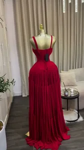 Detailed back view of an elegant red pleated high-waisted floor-length evening strap dress