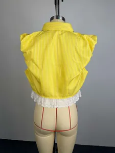 Detailed back view of a yellow striped blouse featuring white lace hem and beads