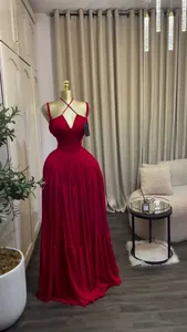 Elegant long red pleated dress with a cross halter neck design on a mannequin display