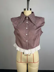 Detail of striped sleeveless shirt with rhinestone collar and lace hem