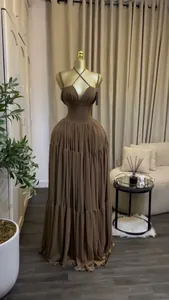 Elegant brown pleated high waist maxi dress shown on a golden mannequin indoors