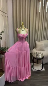 Elegant tiered pink pleated high waist long cami prom dress shown on a golden mannequin