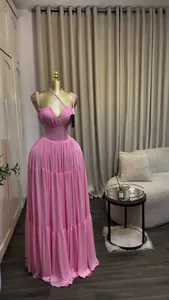 Detailed view of an elegant pink tiered pleated maxi dress with halter neck on a mannequin