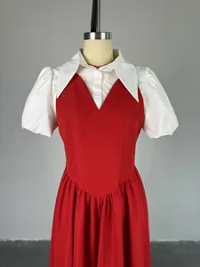 Detailed close-up showing the elegant red high waist dress with white puff sleeves