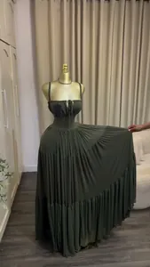 Detailed view of an elegant olive green pleated high waist maxi dress on a golden mannequin