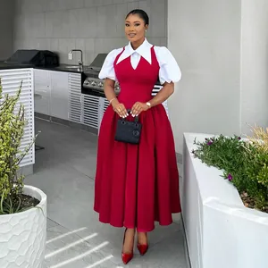 Elegant high-waisted red dress with white puff sleeves and shirt collar on model.