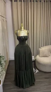 Elegant dark olive green pleated high-waist maxi dress displayed on a golden mannequin