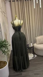 Detailed back view of an elegant olive green pleated maxi dress with lace-up straps