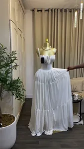 Elegant white tiered maxi dress featuring a high-waisted pleated design and thin straps