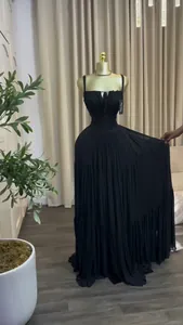 Detail view of the elegant black pleated high-waist tiered maxi dress on mannequin