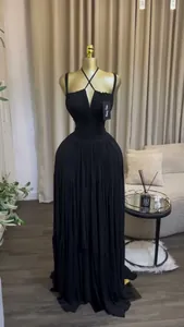 Elegant black pleated maxi evening camisole dress shown on a golden neck mannequin