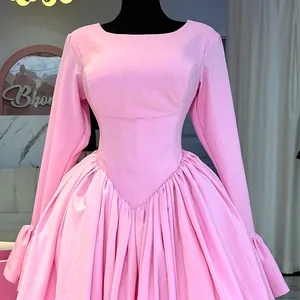 Elegant pink long-sleeved high-waist A-line dress featuring a pleated flared skirt