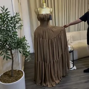 Elegant brown high-waist pleated maxi dress with spaghetti straps shown on a mannequin
