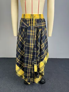 Detail view of yellow and black plaid A-line skirt with tie-front and irregular hem