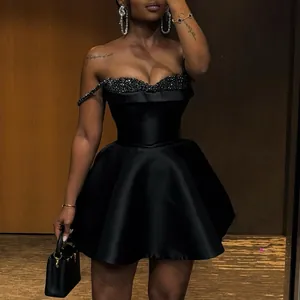 Elegant black strapless mini dress with sequin detail on bust, modeled view.