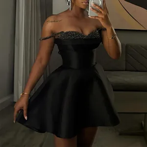 Detailed view of an elegant black sequin patchwork strapless mini dress on a model