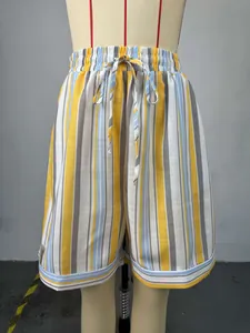 Close-up of vibrant yellow and blue striped high-waisted shorts with drawstring waist