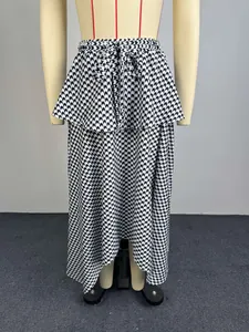 Detail view of high-waist irregular midi skirt with black and white wave pattern
