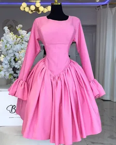 Elegant pink long-sleeved A-line dress with ruffled cuffs and puffy skirt detail