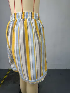 Close-up side view of colorful striped high-waisted summer shorts on a mannequin display